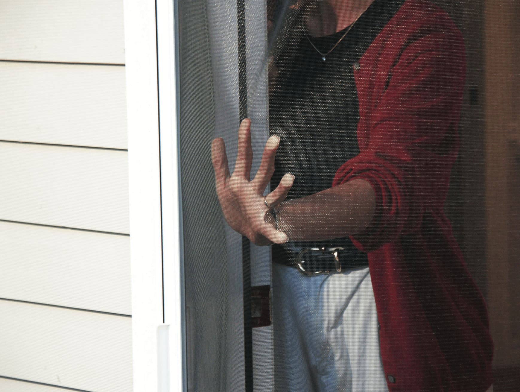 Person touching a mosquito screen